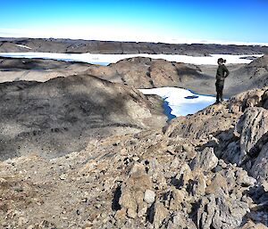 An expeditioner standing on a hilly lockout