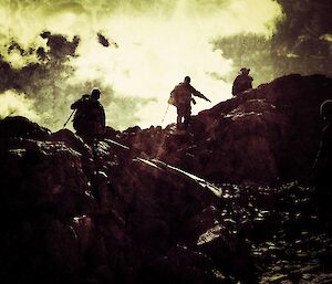 A silhouette view of expeditioners on their walk with the sun in the background