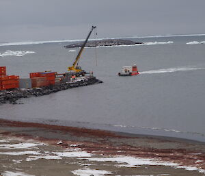 A barge on water near the wharf at Davis doing resupply