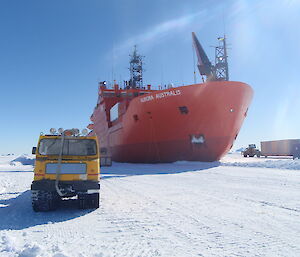 Unloading cargo from the ship fast in the ice to a waiting truck