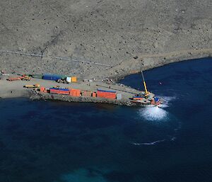 Davis crane unloading the barge at the wharf