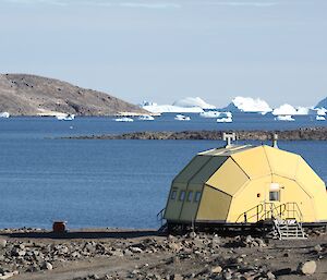 Looking out over the water with the yellow Pineapple shaped hut in the forground.