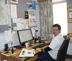 Jason sitting at his desk