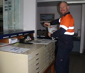 Richard printing the daily papers that he downloads over the internet each morning