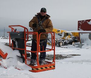 Tim in the elevated platform at ground level ready to get on the roof of a building