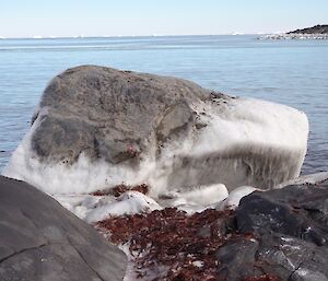 Shore line rocks coated with frozen sea spray