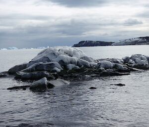 Shore line rocks coated with frozen sea spray