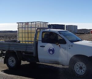 The station four wheel drive ute with a 1000 litre water container on the tray