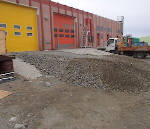 A large pile of soil added to the ramp in front of the work shop door