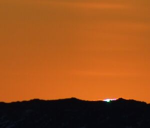 A slight green tinge at the suns location just as it goes down behind Gardner Island