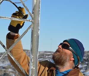 Expedition at an antenna looking at the end of a cable that he believed to have a short