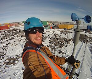 Bureau of Meteorology technician on top of the weather station tower undertaking routine maintenance