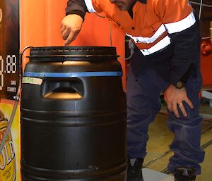 Mark the Brew Master checking a brew in a plastic drum