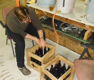 Keith filling bottles from the plastic brew drum with a special filling wand