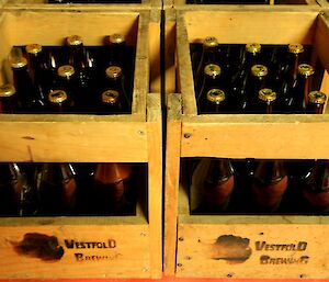 Two crates of full beer bottles side by side