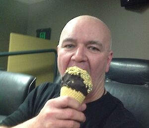 Expeditioner trying to the first bite of his massive chock top ice-cream