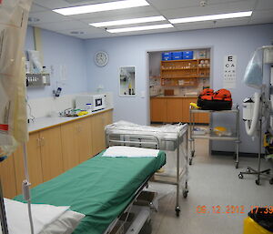 View of the medical assessment area, showing bed and other medical instruments