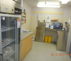 View of the scrub room sinks and cabinets