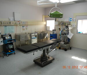 View of operating theatre and instruments with operating table taking centre stage