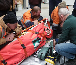 Doc provides training for expeditioners on a piece of medical equipment