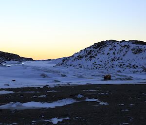 Two quad bikes parked in the distance just of the sea ice