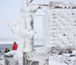 Rime Ice and snow covers an old weather Station, with Tim, Pat and Simon in the background