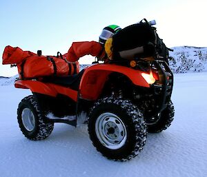 Quad bike loaded up with safety equipment parked on the sea ice