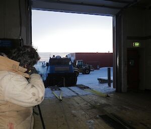 The blue Hägglunds being winched up the workshop ramp