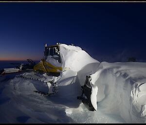 Snow-groomer covered in snow