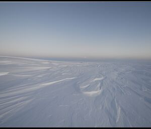 Photo of the Plato with snow covered green aviation fuel drums in the distance