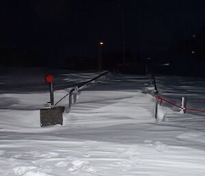 Snow almost to the top of the walkway handrail