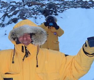 Two expeditioners dress in cold weather clothing to keep warm