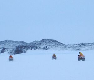 Three quad bikes ahead in the distance as we ride down Long Fjord