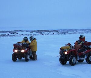 Expeditioners on quad bikes stopped to check their location on the map