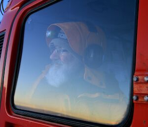 Dr Mal peering out of the Hagg at the bergs and the twilit horizon