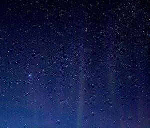 Aurora Australis and star field with dawn breaking on the horizon