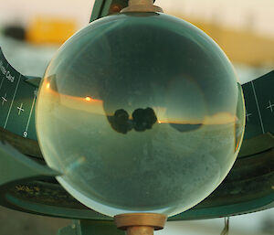 Sun rise reflected in glass sphere of a sunshine recorder