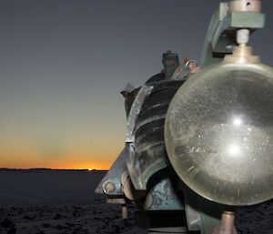 Mirage Sun rises on the horizon above the sea ice with sunshine recorder in foreground