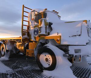 The sun shining on the Mack truck which stood the test of Mother Nature with only snow the trace of the past blizzard