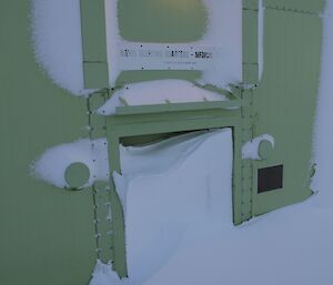 The back door of the Sleeping and Medical Quarters ¾ buried in snow after the blizzard