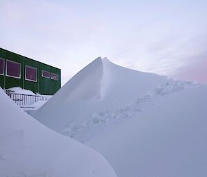 Two massive mounds of snow in front of the Living quarters front deck