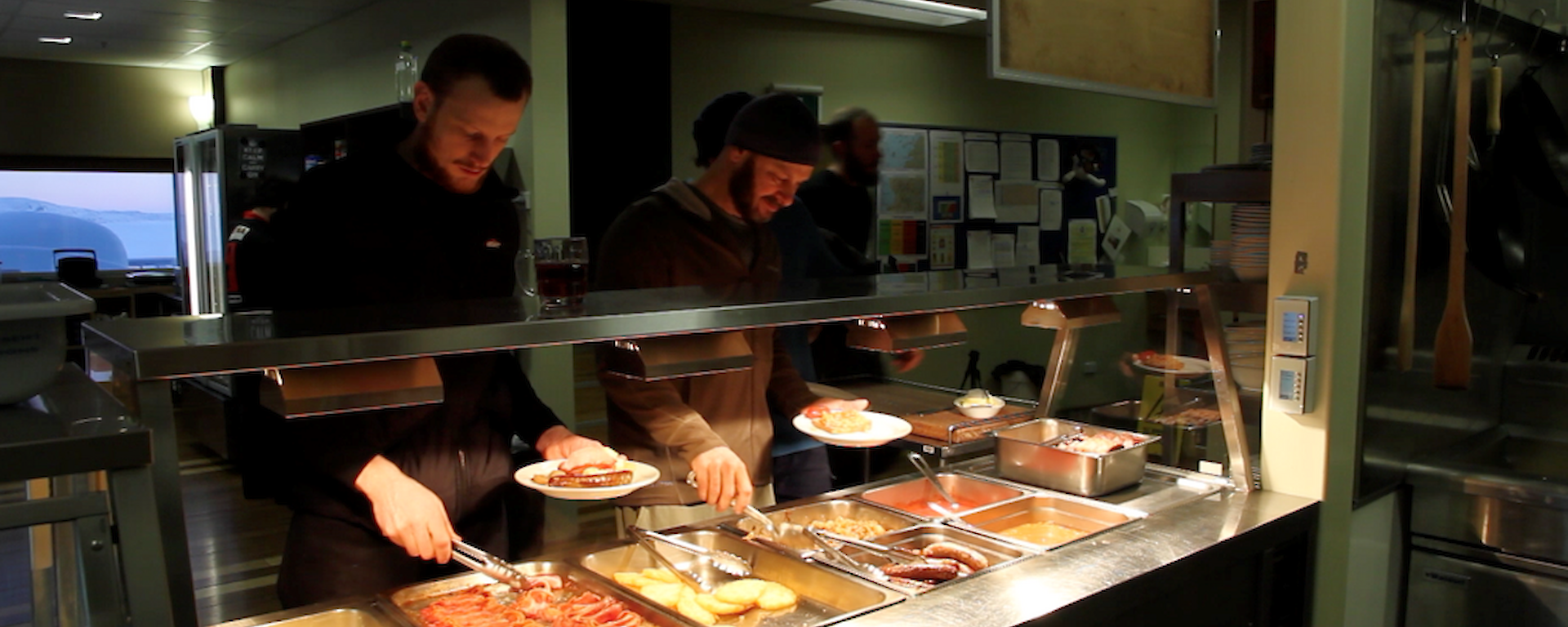 Expeditioners line up for a hearty cooked breakfast before heading out into the cold to film