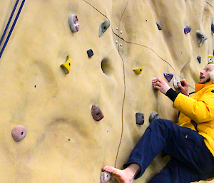 Expeditioner bouldering on the indoor climbing wall