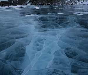 Cracks in the frozen fresh water lake lead of in many directions