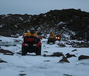 Three expeditioners riding their quad bikes along the frozen creek