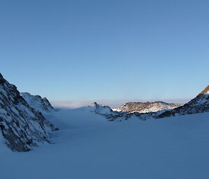 Looking up to the plateau along the snow drift within the valley with the Melon just of centre to the right