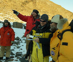 Bob and Rich check their location on the map while Tim and Aaron offer assistance