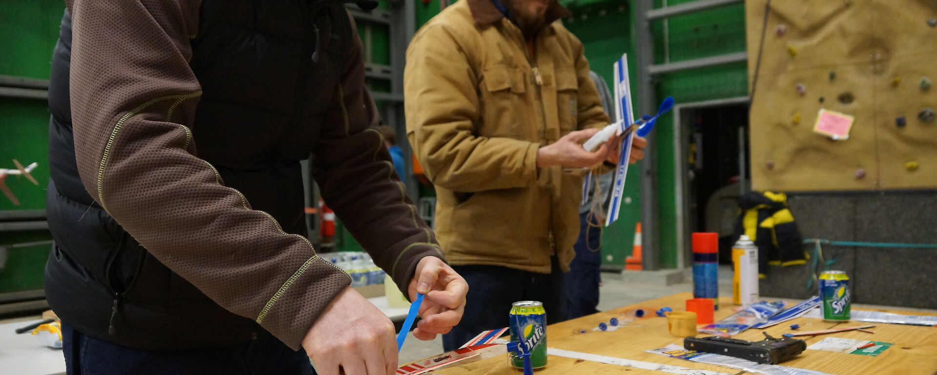 Richard and Simon at table preparing balsa aircraft