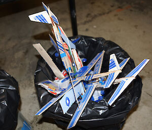 Discarded balsa aircraft in bin