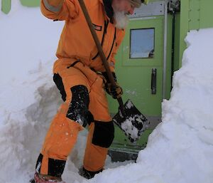 Dr Malcolm digging the snow away from the back door with a shovel